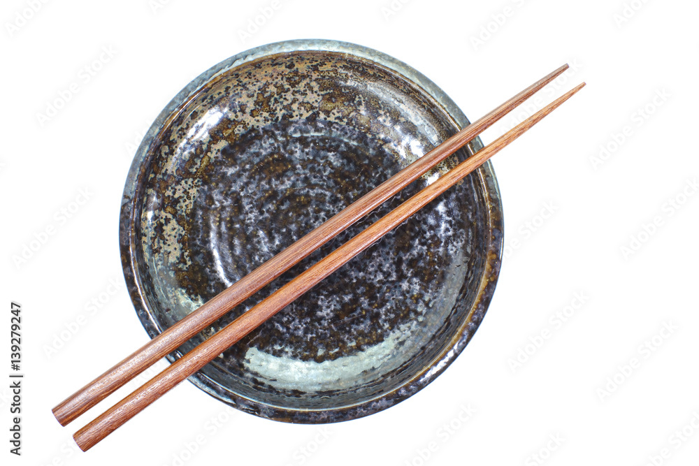 Black ceramic plate and wood chopstick on white background