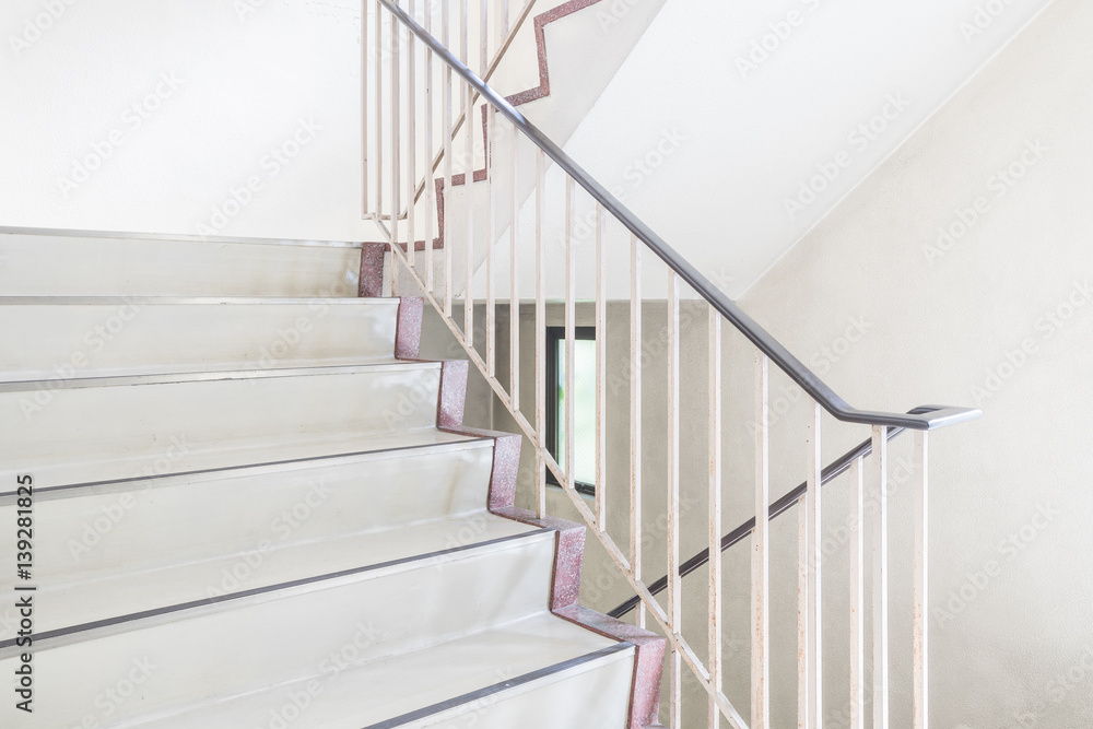 Concrete staircase with metallic handrail at modern buiding