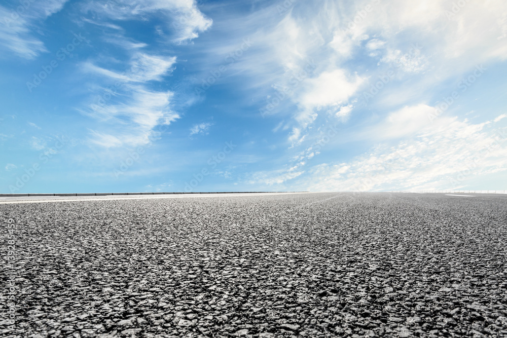 asphalt road under the blue sky