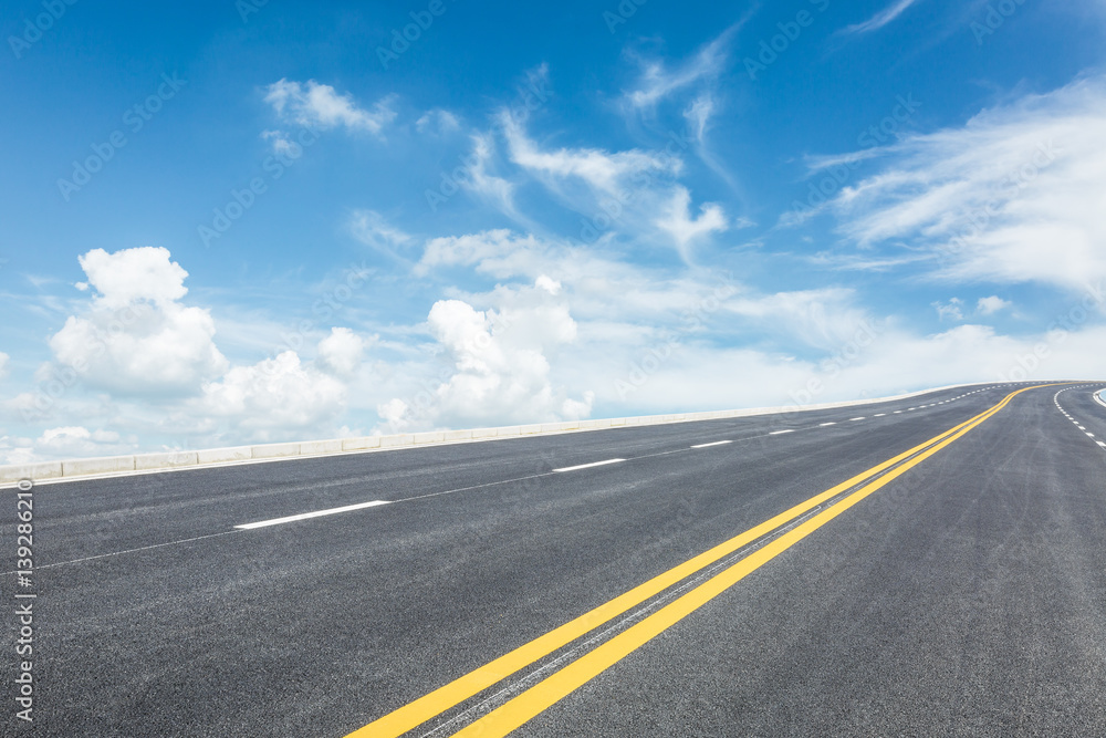 asphalt road under the blue sky