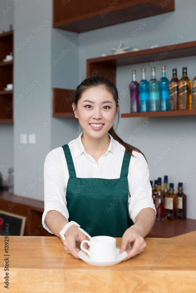 young pretty woman works in cafe