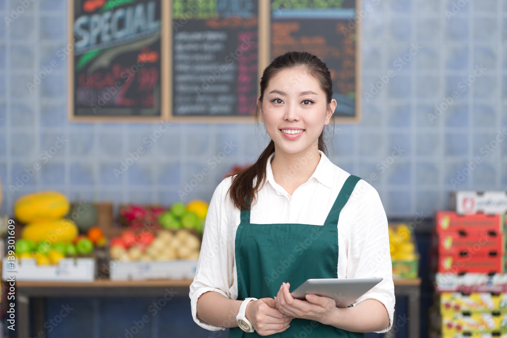 young pretty woman works in fruit store