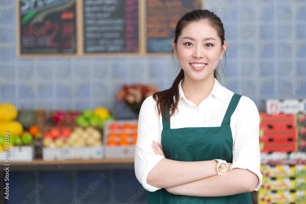 young pretty woman works in fruit store