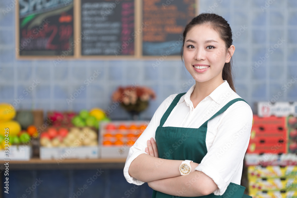 young pretty woman works in fruit store