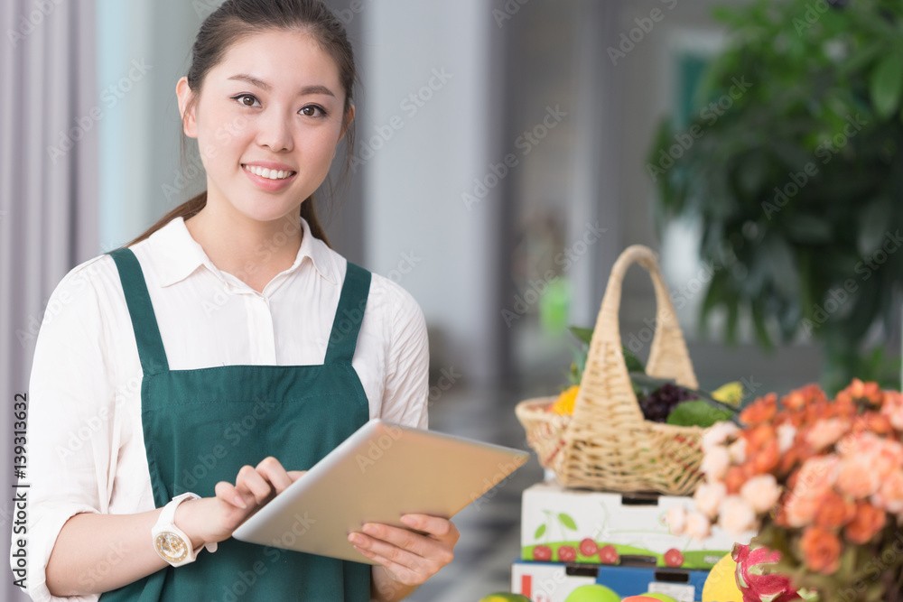 young pretty woman works in fruit store