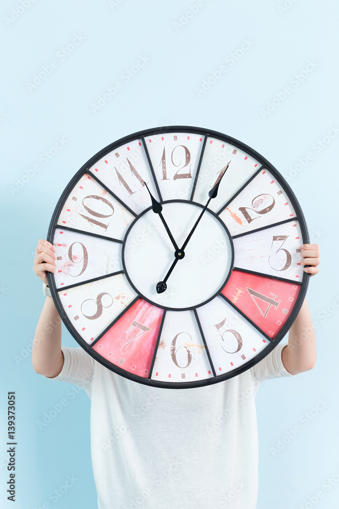 young pretty woman with clock