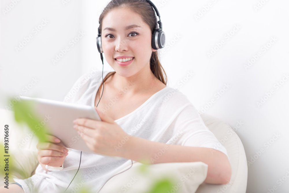 young pretty woman relaxes with tablet