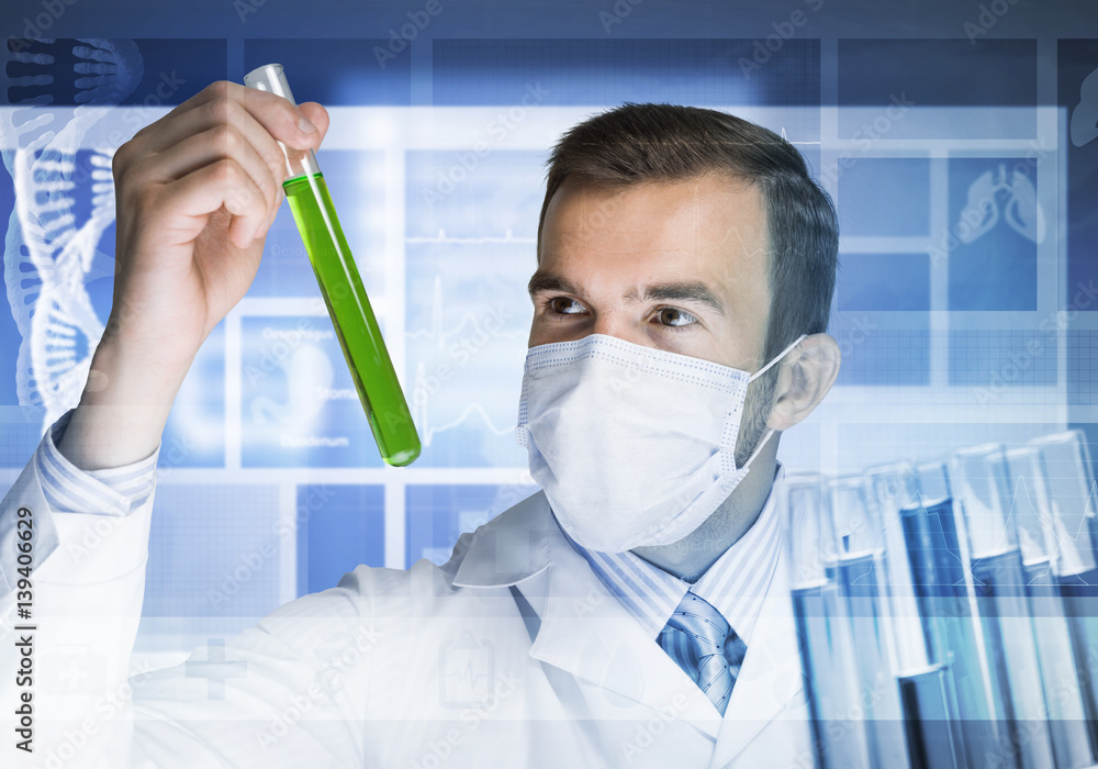 Portrait of concentrated male scientist working with reagents in laboratory