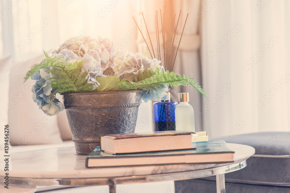 Modern workplace with tree pot and reed freshener on coffee table