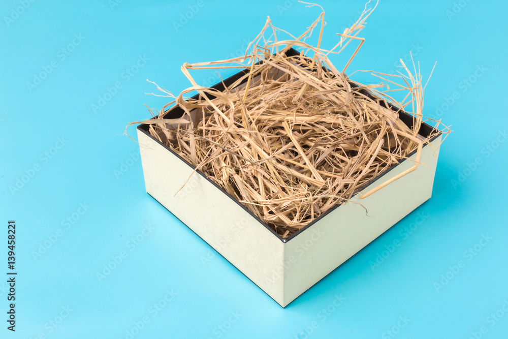 house model cardboard in a box with hay and free copyspace house concept