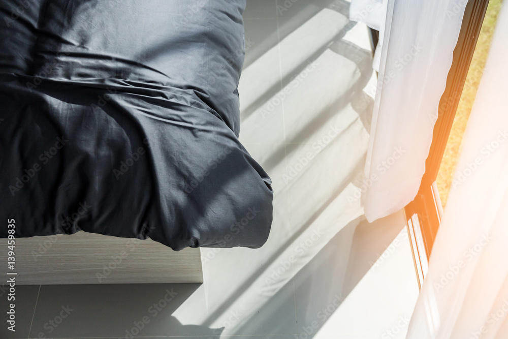 Bed maid-up with clean white pillows and bed sheets in beauty room. Close-up. Lens flair in sunlight