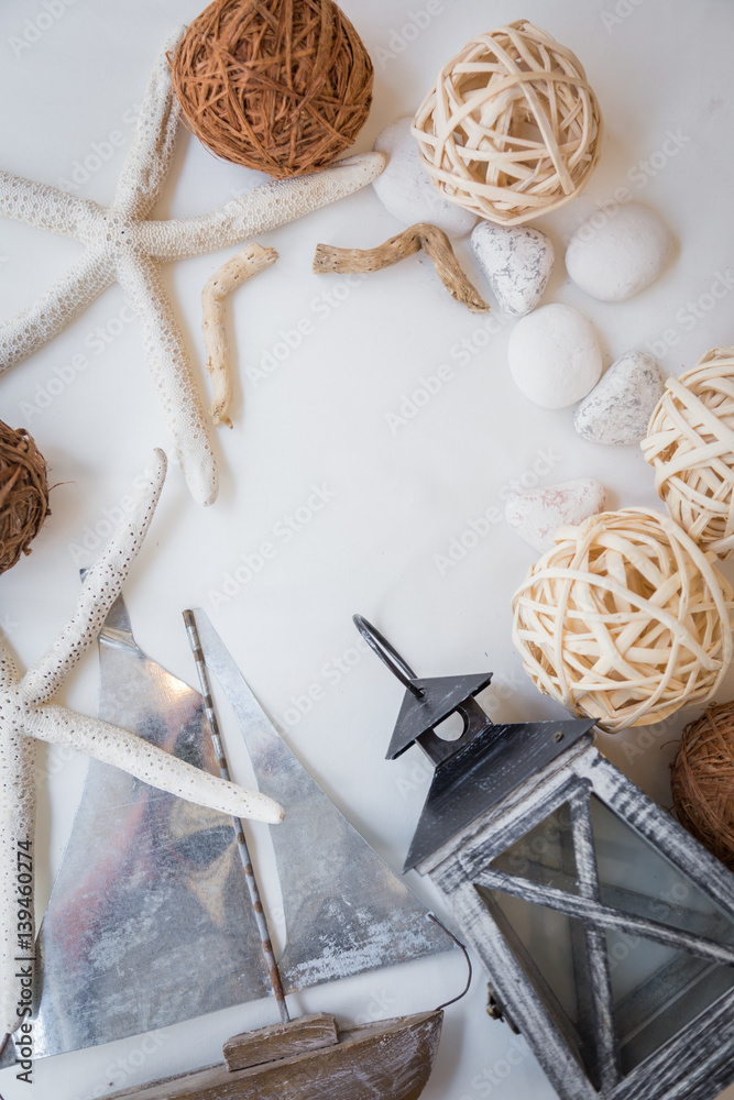 summer concept with boat starfish lantern stone rattan ball on white floor background