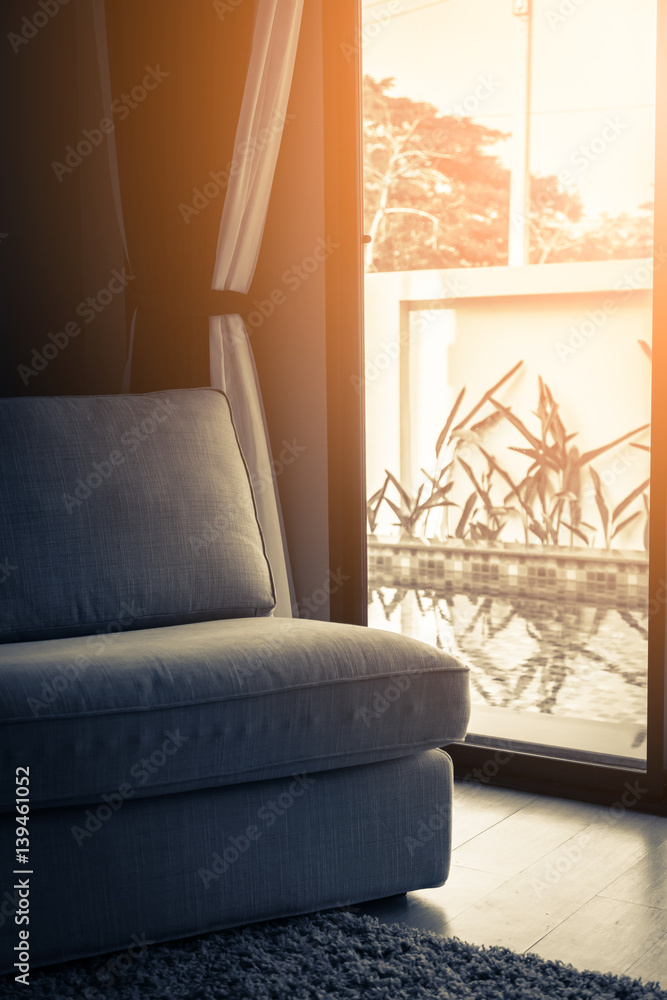 contemporary interior of Living room with part of sofa in sunny day and white curtain interior backg