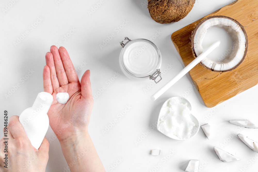 organic cosmetics with coconut on white background top view