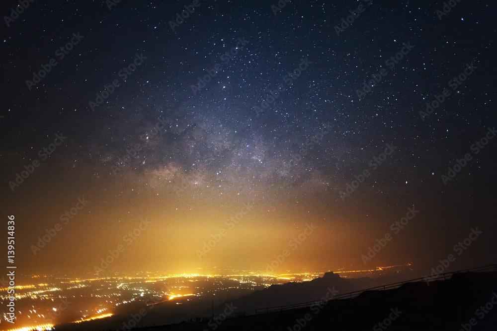 Milky way galaxy and city light at Phutabberk Phetchabun in Thailand.Long exposure photograph.With g