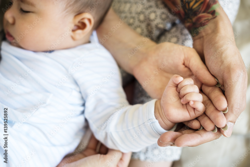 Father and mother are taking care of their child.