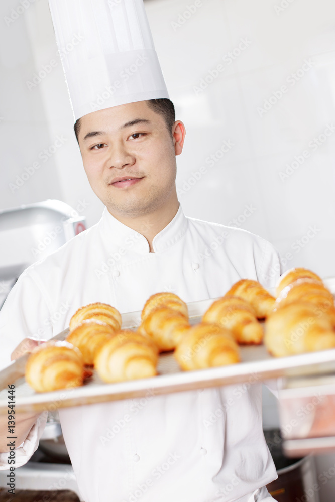 young man chelf makes bread in kitchen