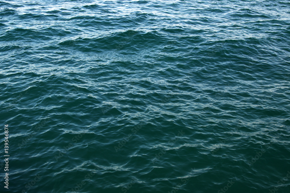 Blue sea surface with waves