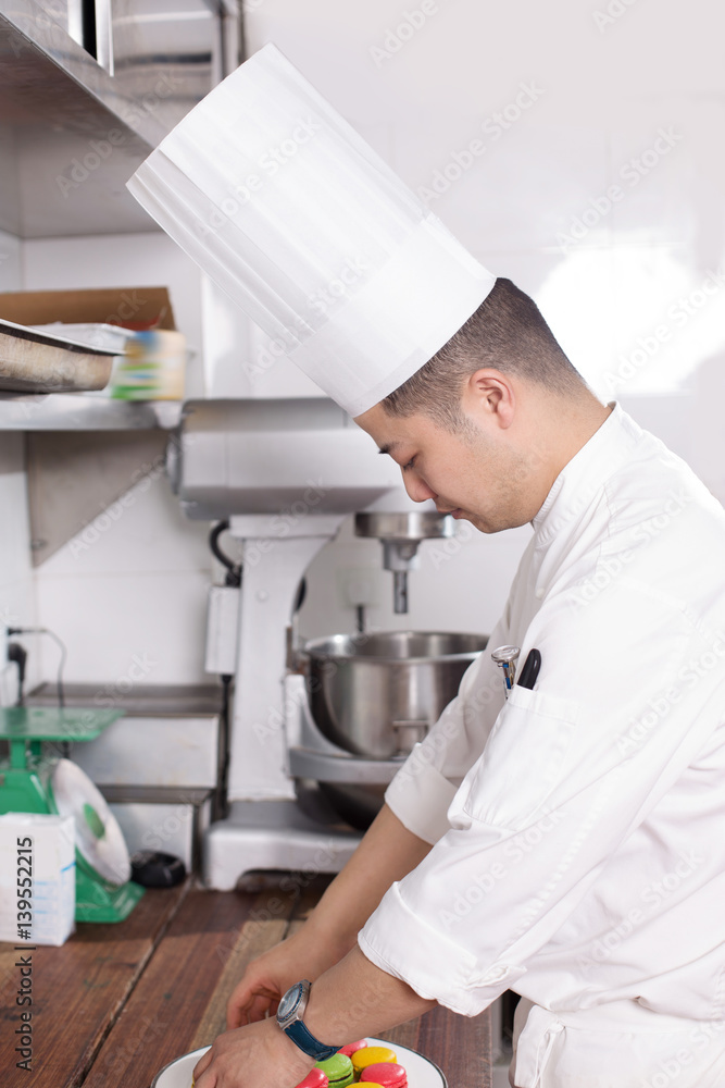 young man chelf makes food in kitchen