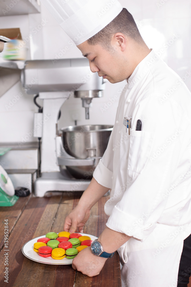 young man chelf makes food in kitchen