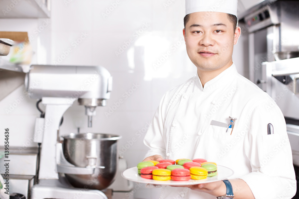 young man chelf makes food in kitchen