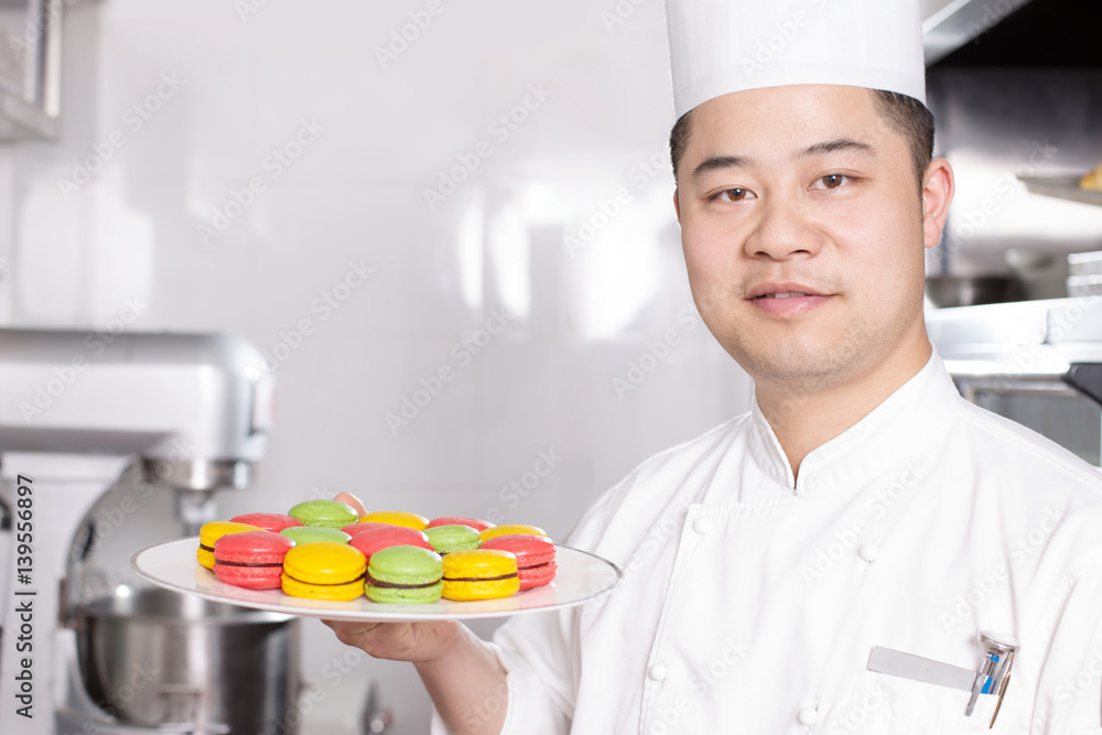 young man chelf makes food in kitchen