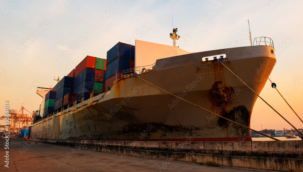 container ship in import export and business logistic.By crane , Trade Port , Shipping.Tugboat assis