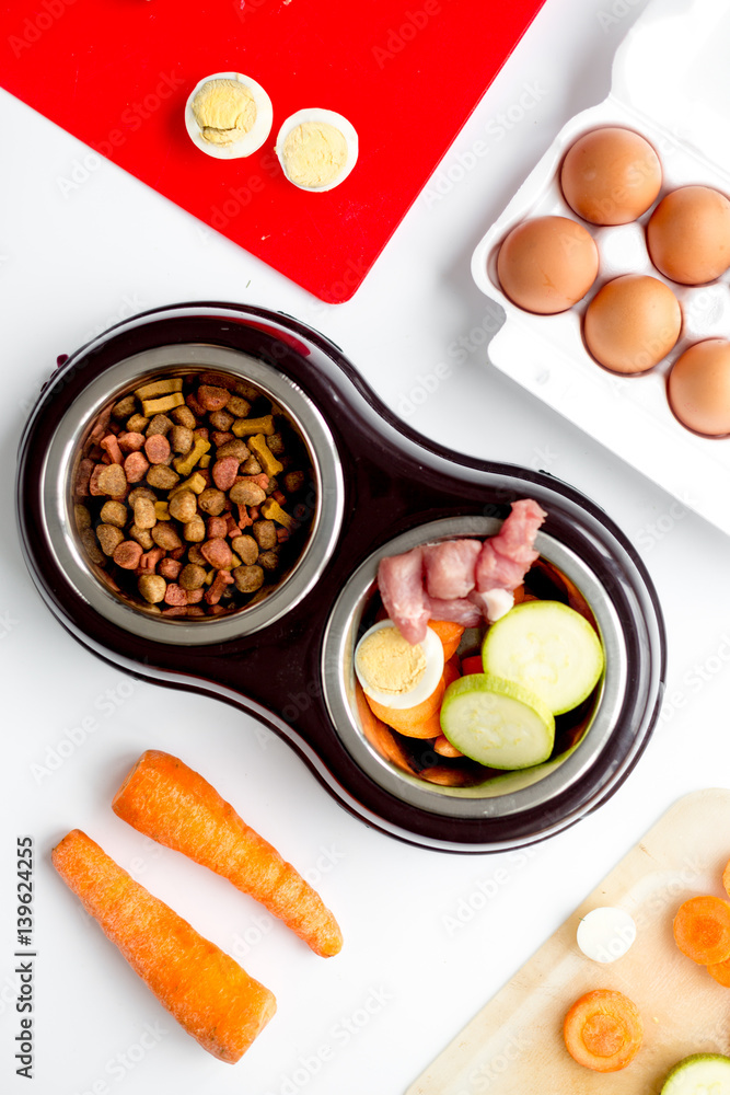 Dogfood set with vegetables, eggs and meat on table background top view