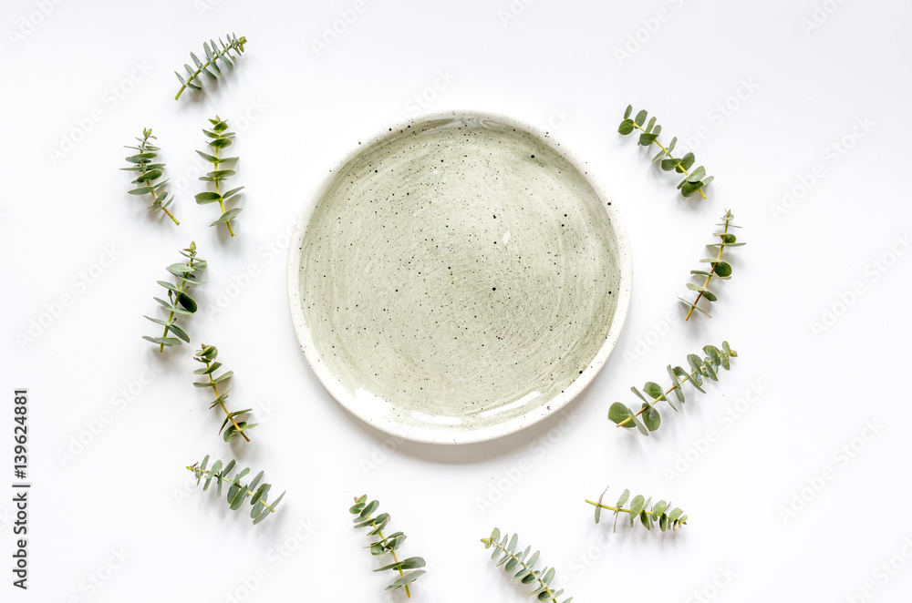 Spring design with plate and eucalyptus on white background top view mockup