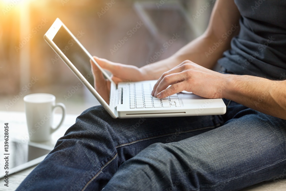 Man works on laptop.