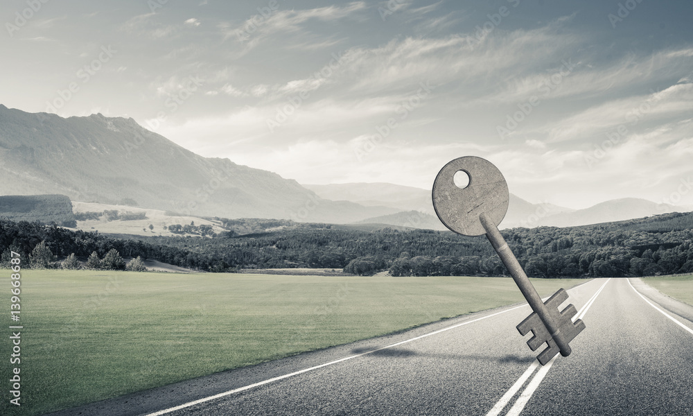 Conceptual background image of concrete key sign on asphalt road