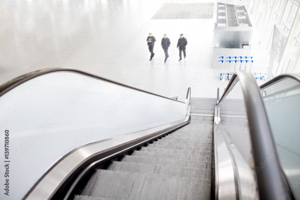 Top view on the escalators with people walking at the airport