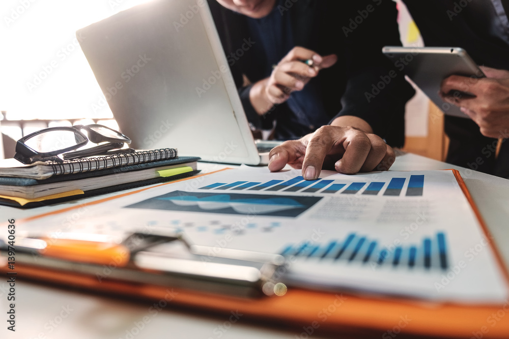 Businessman making presentation with his colleagues and business tablet digital computer at the offi