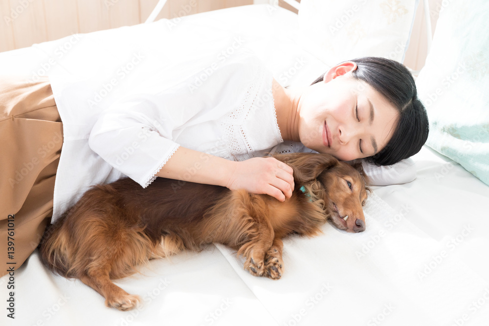 young asian woman sleeping with dog