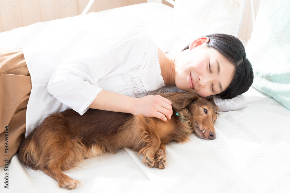 young asian woman sleeping with dog