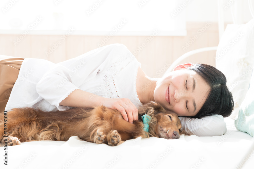 young asian woman sleeping with dog