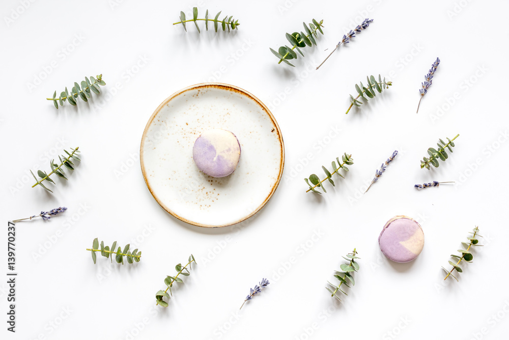 light breakfast with macaroons on spring pattern white background top view