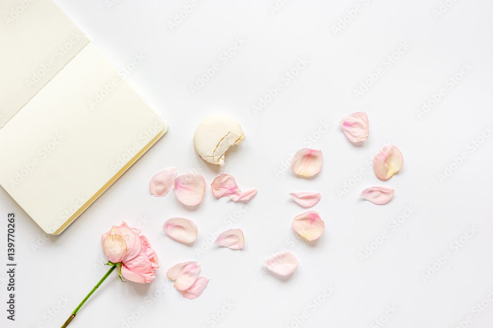 woman table with rose and notebook in pastel color top view mockup