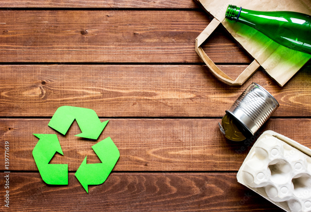 environment concept with recycling symbol on wooden background top view mock up