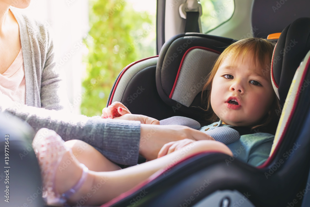 Toddler girl in her car seat