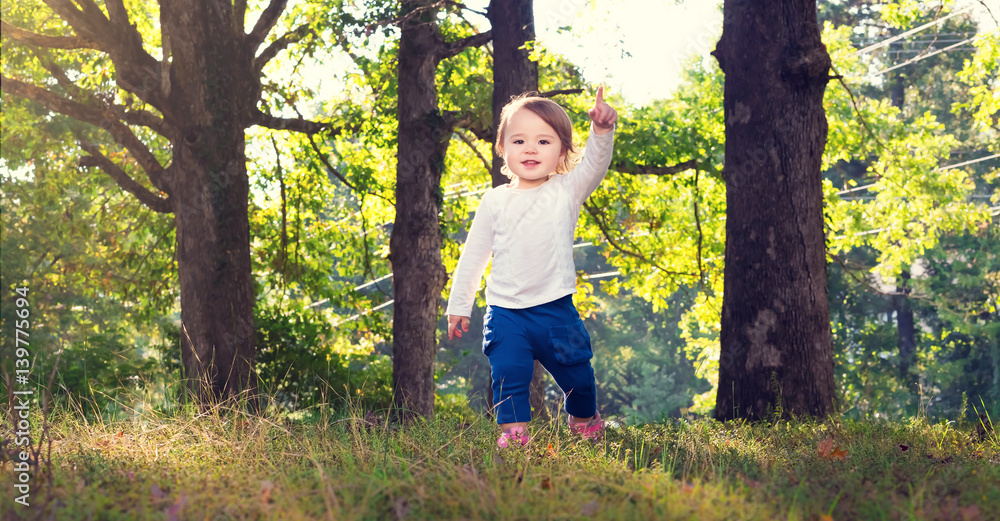 Happy toddler girl playing outside