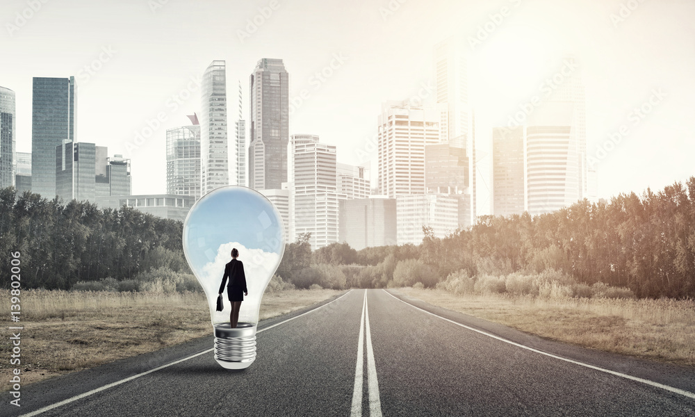 Businesswoman inside light bulb