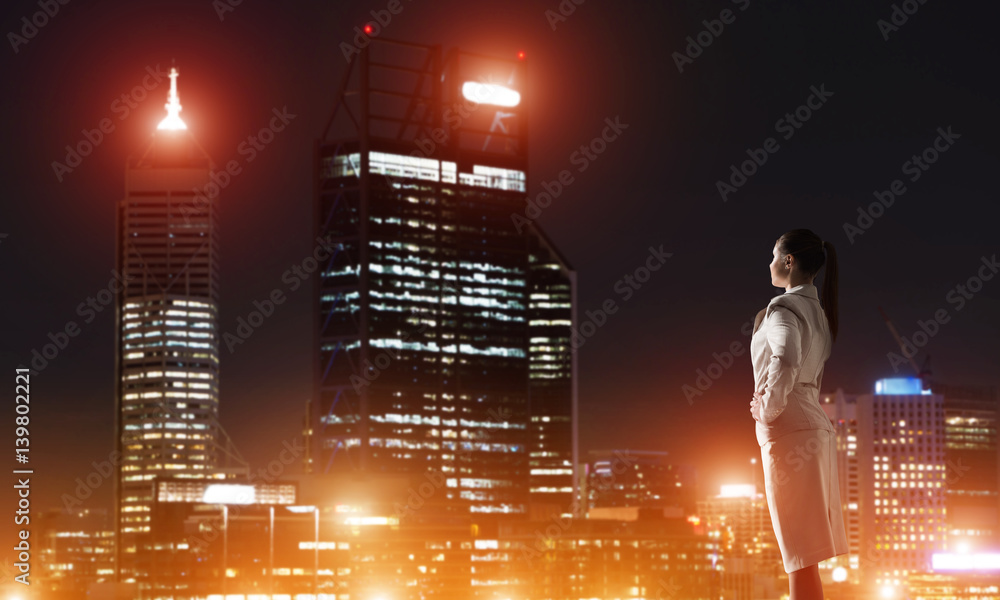 Woman looking at night city