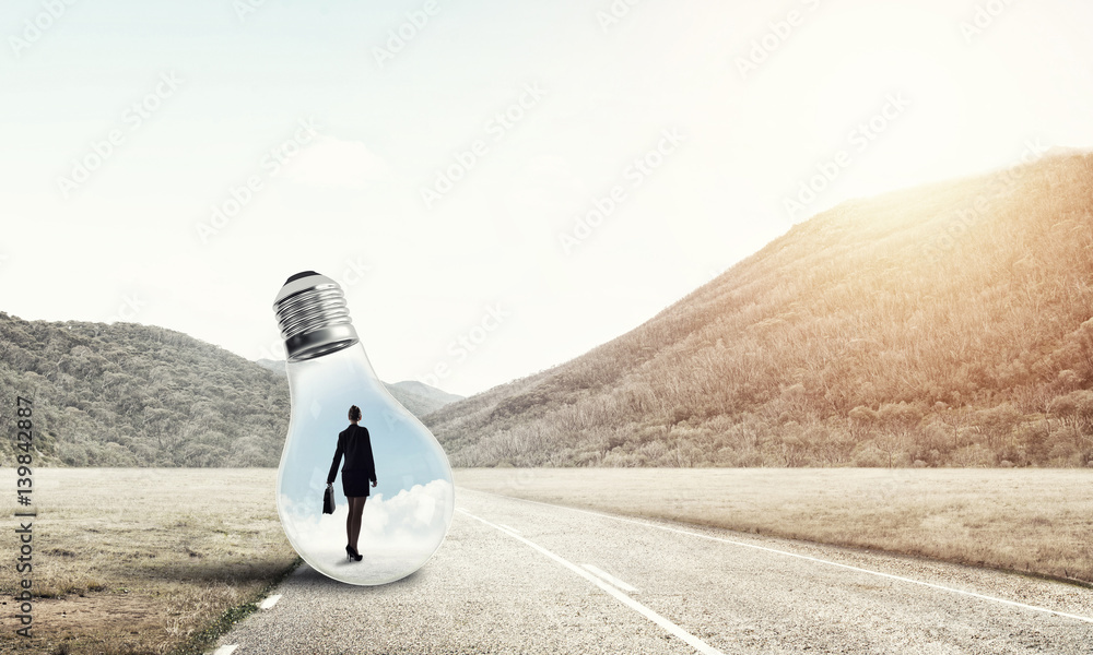 Businesswoman inside light bulb