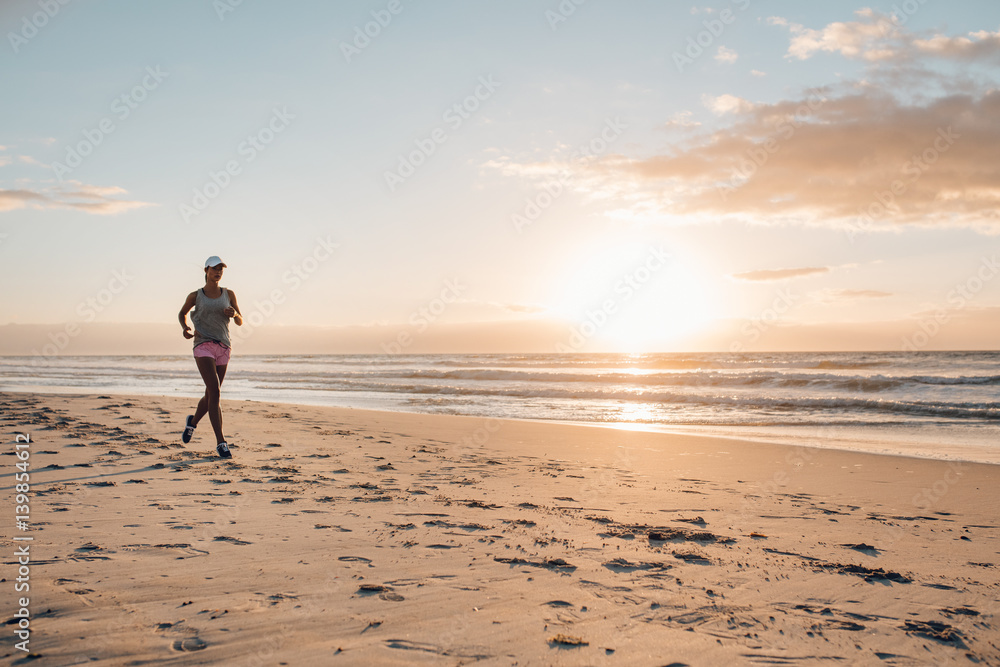 Fitness woman doing running exercise on the beach