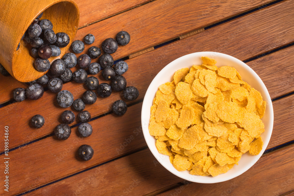 Corn Flakes and blue barry into a bowl