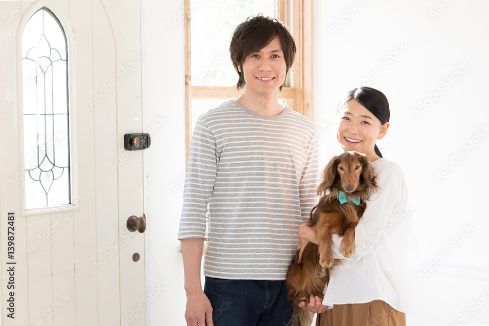 young asian couple with dog relaxing in the room