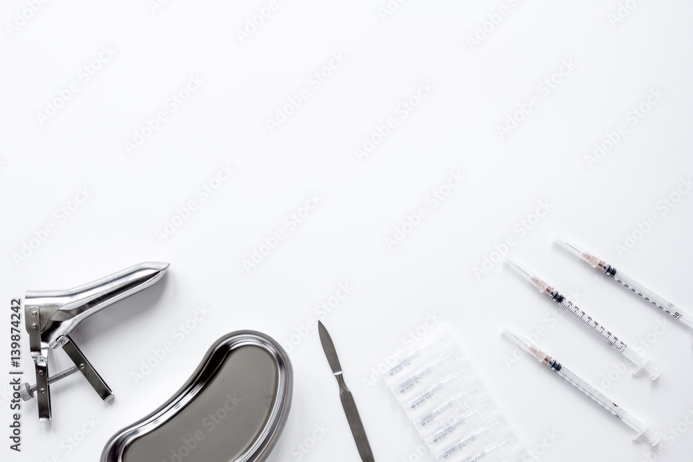 instruments of gynecologist on white background top view mock up