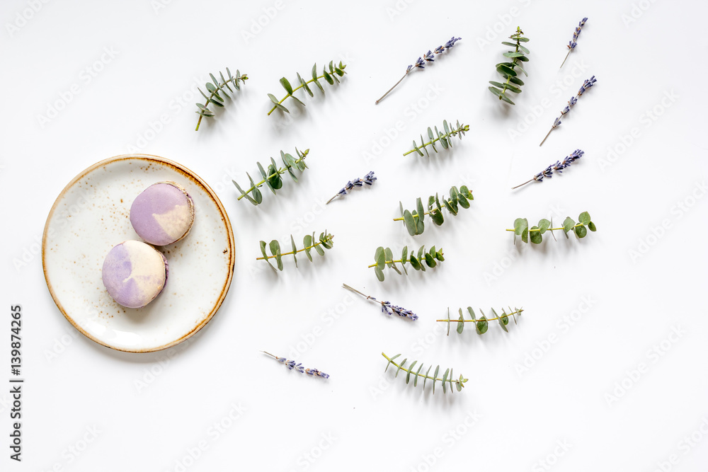 woman table with macaroons lavander and eucalyptus top view