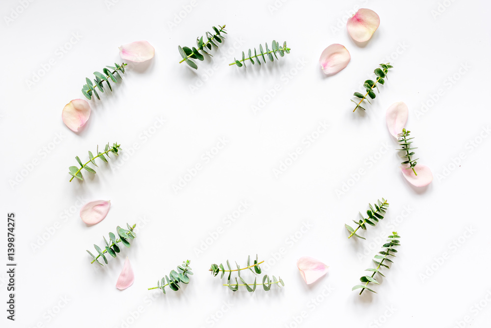 floral mock-up with rose petals and eucalyptus on white table top view